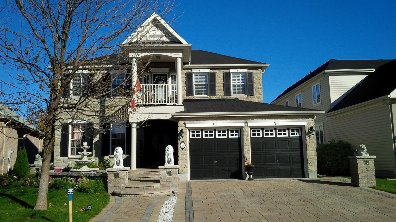 A curved walkway connects the driveway to the front entrance.