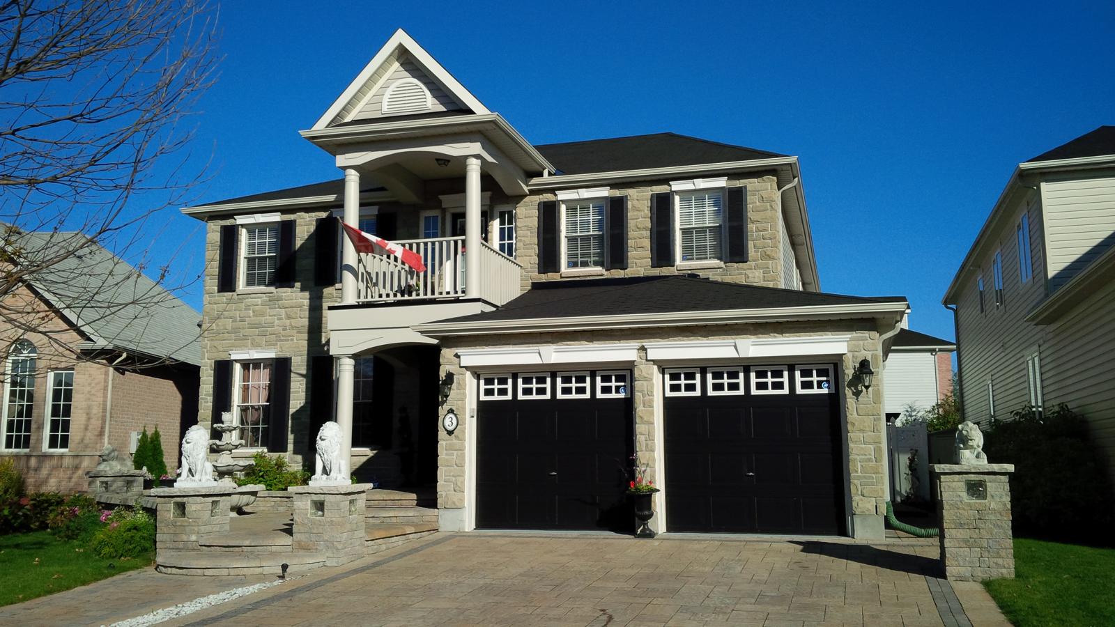 Interlock driveway, curved entry steps and stone garden walls.