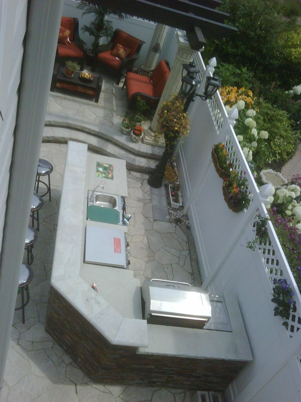 A wraparound counter and stone-faced base beside the patio lounge.